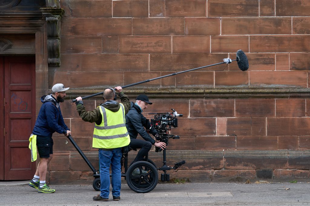 Behind the scenes on Govan Fair Queen: boom operator and camera crew on a Glasgow street
